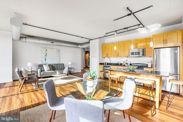 dining room with light wood-type flooring and sink