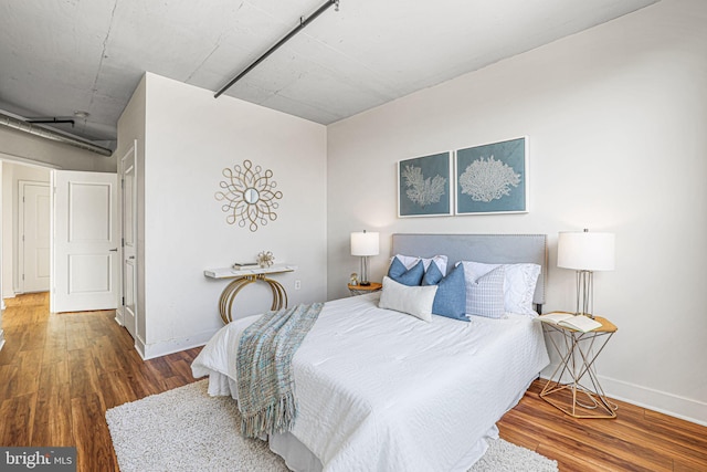 bedroom featuring dark hardwood / wood-style flooring