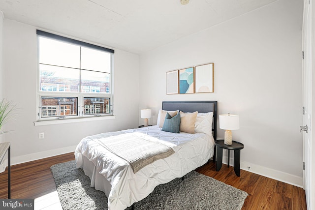 bedroom with dark wood-type flooring