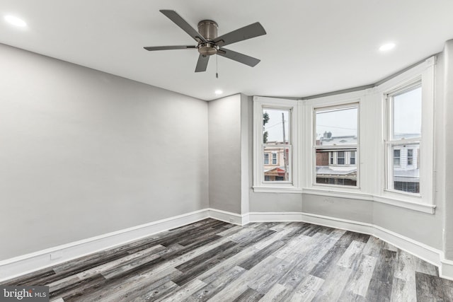 unfurnished room featuring hardwood / wood-style floors and ceiling fan