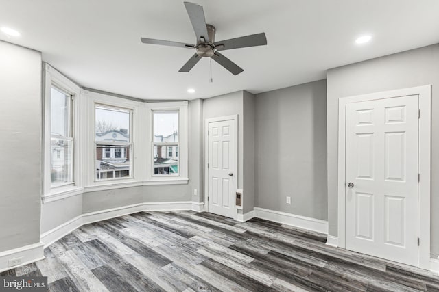 unfurnished room featuring ceiling fan and dark hardwood / wood-style flooring