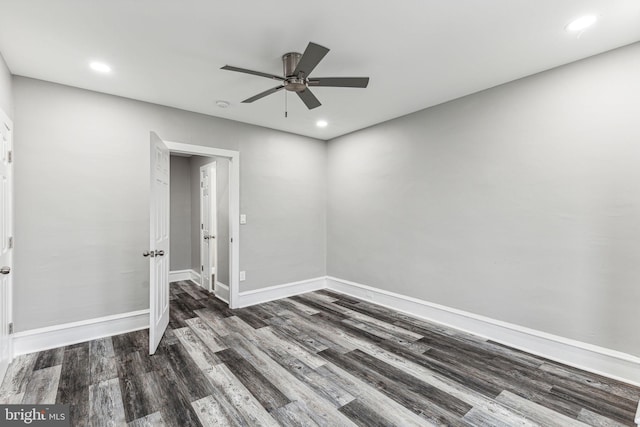 unfurnished room with ceiling fan and dark wood-type flooring