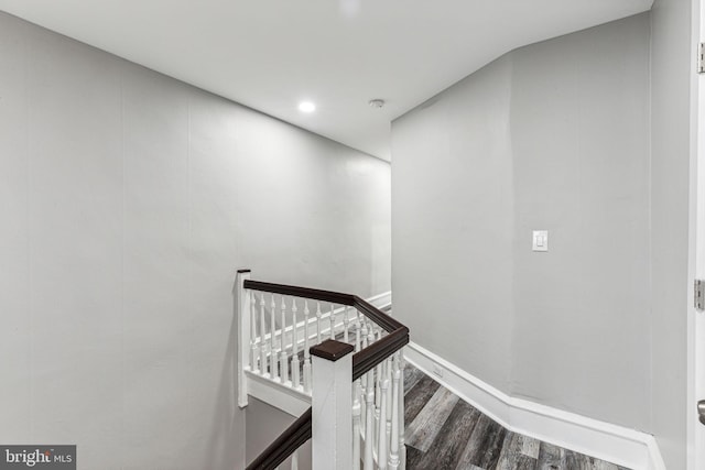 stairs featuring wood-type flooring