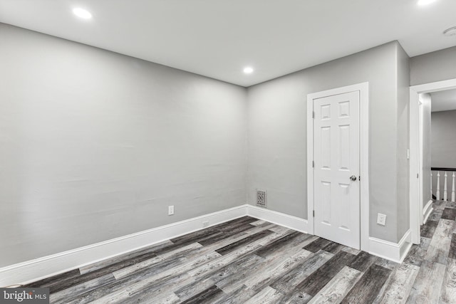 spare room with dark hardwood / wood-style flooring