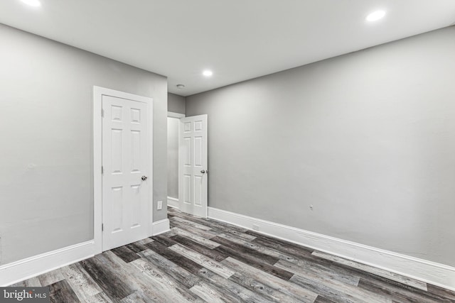 empty room with dark hardwood / wood-style flooring