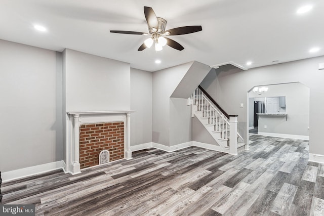 unfurnished living room with hardwood / wood-style flooring and ceiling fan