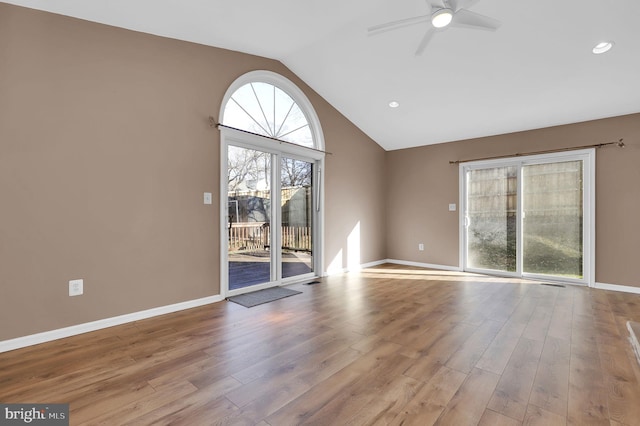 interior space with ceiling fan, light hardwood / wood-style floors, and lofted ceiling