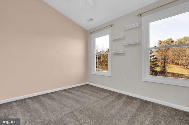 carpeted spare room featuring ceiling fan and lofted ceiling