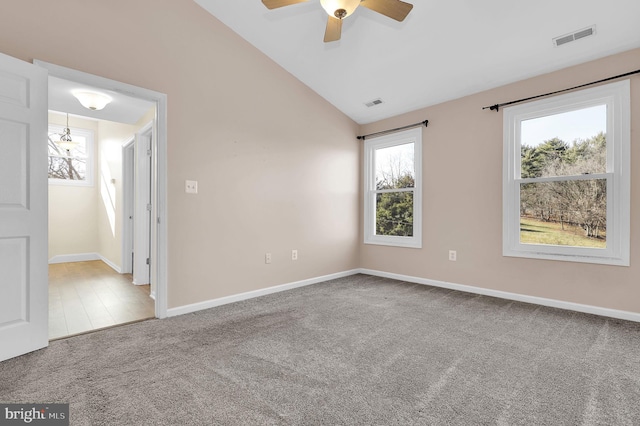 empty room featuring ceiling fan, carpet, and lofted ceiling