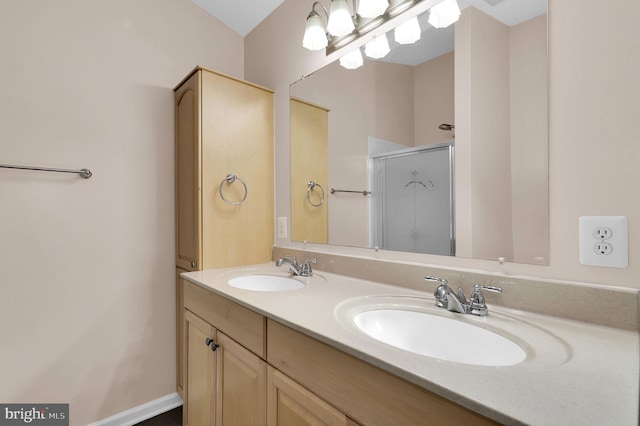 bathroom with a shower with door and vanity