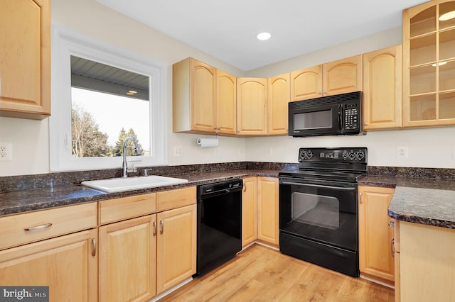 kitchen with black appliances, light wood-type flooring, sink, and light brown cabinetry