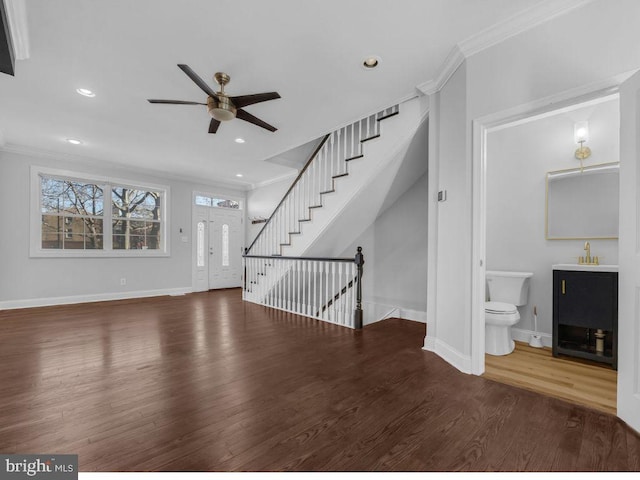 unfurnished living room with ceiling fan, dark hardwood / wood-style flooring, ornamental molding, and sink