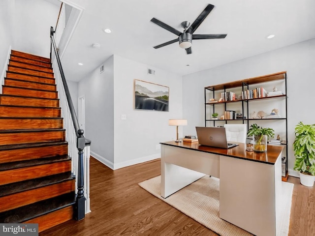 unfurnished office featuring ceiling fan and dark hardwood / wood-style floors