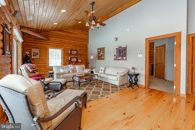 living room with wood-type flooring, high vaulted ceiling, ceiling fan, and wooden ceiling