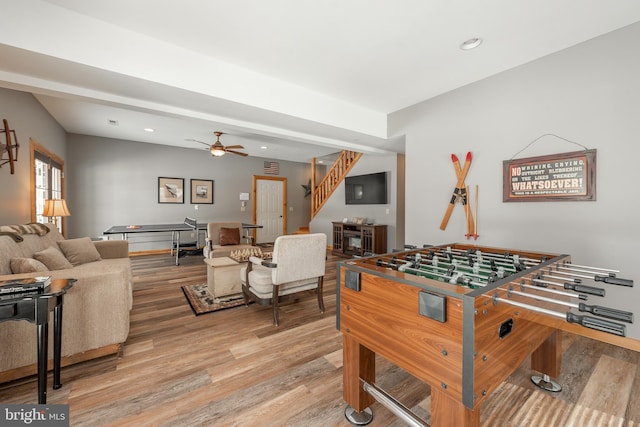 playroom with ceiling fan and light wood-type flooring