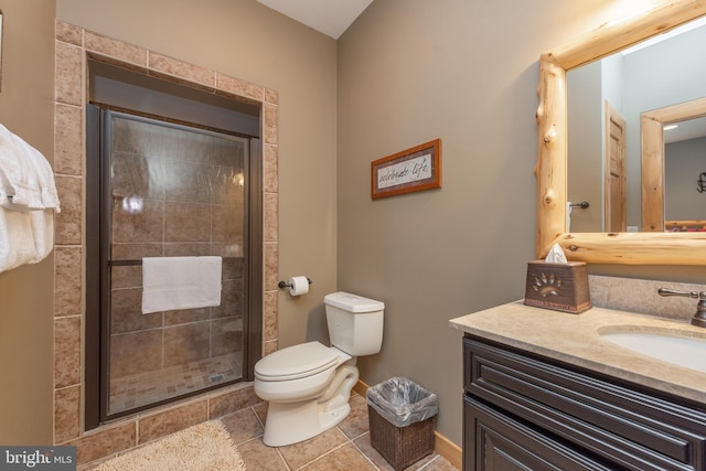 bathroom with tile patterned flooring, vanity, toilet, and an enclosed shower