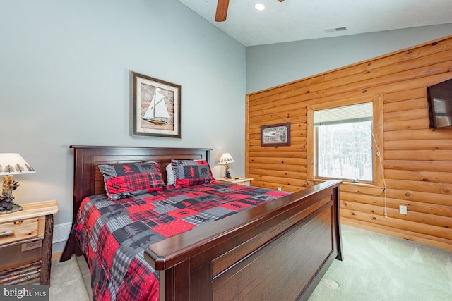 carpeted bedroom with log walls, ceiling fan, and lofted ceiling