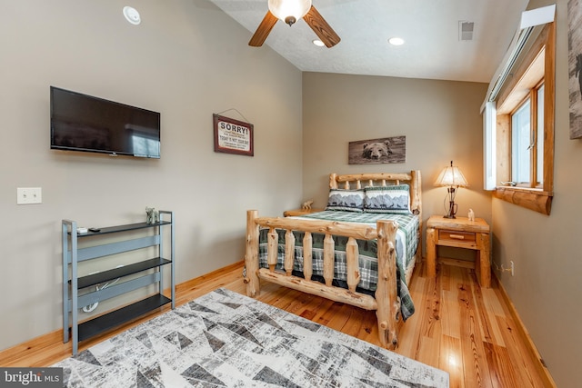 bedroom featuring ceiling fan, lofted ceiling, and light hardwood / wood-style flooring