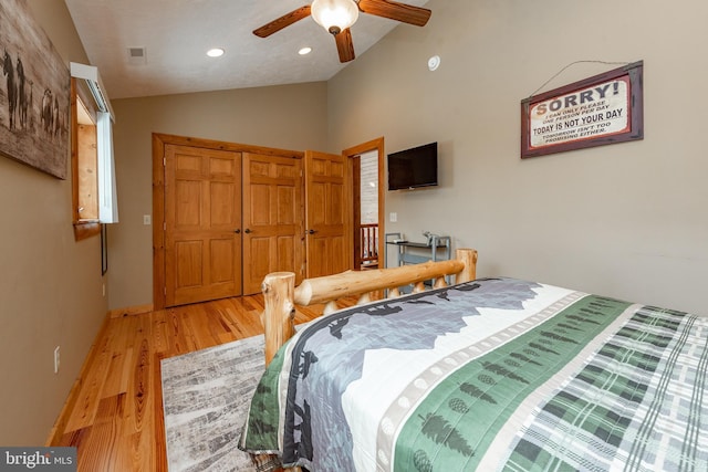 bedroom featuring light hardwood / wood-style floors, ceiling fan, and lofted ceiling