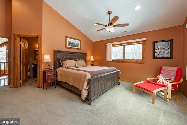 carpeted bedroom with multiple windows, ceiling fan, and vaulted ceiling