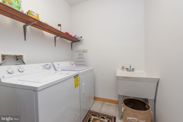 laundry area featuring light tile patterned floors and washer and clothes dryer