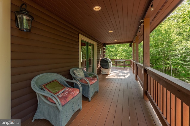 wooden terrace featuring grilling area and a porch