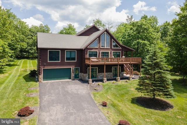 log-style house with a garage, a wooden deck, and a front lawn