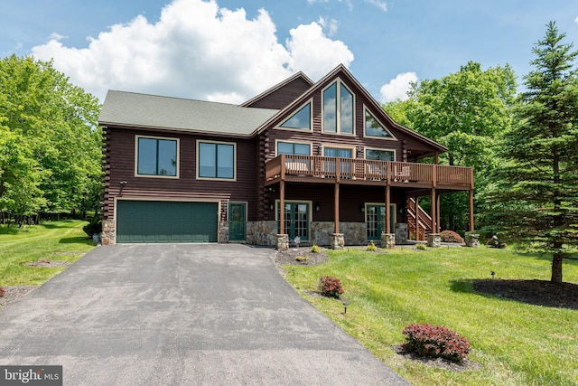 log home with a front yard, a deck, and a garage