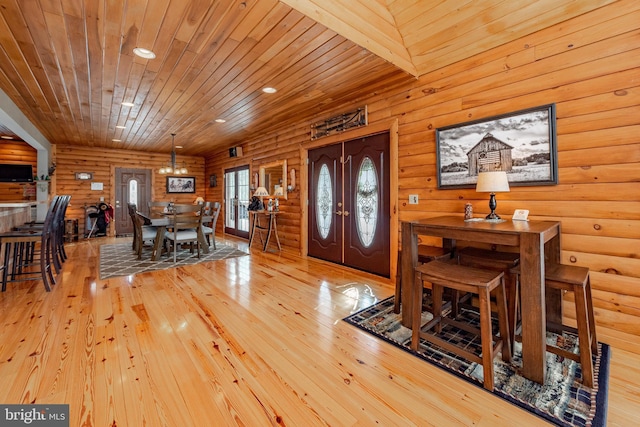 entryway with french doors, light hardwood / wood-style floors, wooden ceiling, and beam ceiling