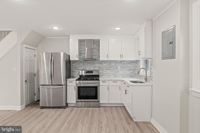 kitchen featuring sink, stainless steel appliances, wall chimney range hood, and light hardwood / wood-style flooring