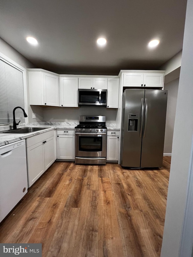 kitchen featuring white cabinets, dark hardwood / wood-style floors, sink, and appliances with stainless steel finishes