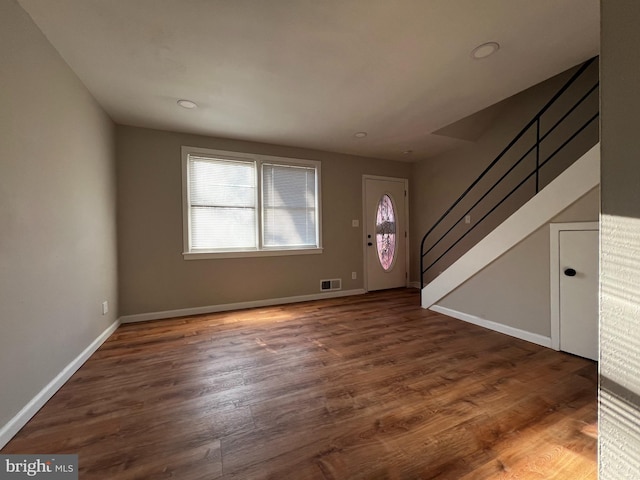 entryway with dark hardwood / wood-style flooring