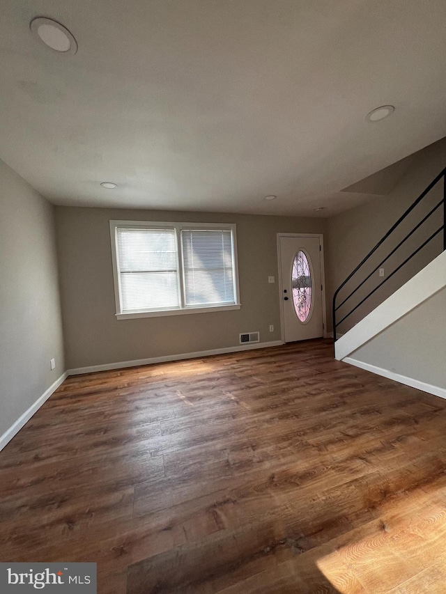 entryway featuring plenty of natural light and dark hardwood / wood-style floors