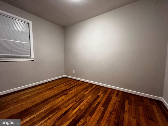 spare room with dark wood-type flooring