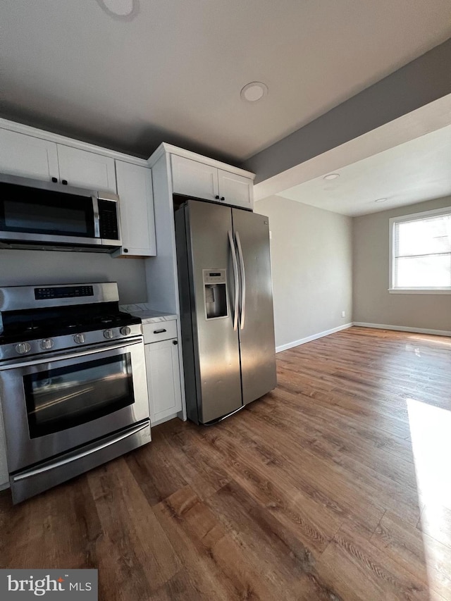 kitchen featuring white cabinetry, dark wood-type flooring, and stainless steel appliances