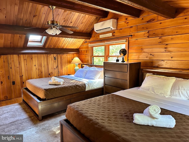 bedroom with ceiling fan, a wall mounted air conditioner, wood walls, wood-type flooring, and vaulted ceiling with skylight