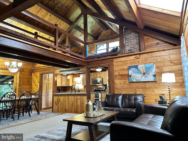 carpeted living room with beamed ceiling, high vaulted ceiling, an inviting chandelier, and wood walls