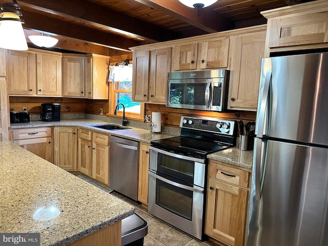 kitchen with beam ceiling, sink, light tile patterned floors, wood ceiling, and appliances with stainless steel finishes