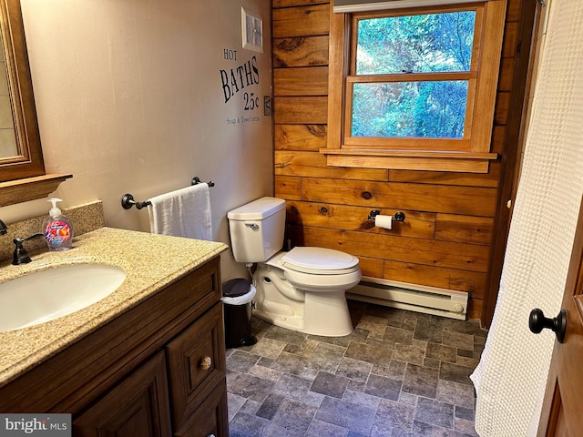 bathroom with vanity, toilet, and a baseboard radiator