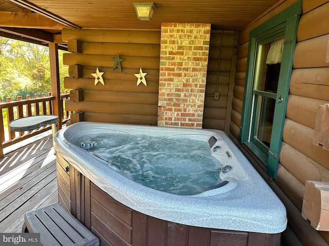 wooden terrace with a hot tub