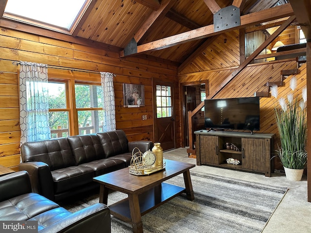 carpeted living room with a skylight, wood ceiling, wooden walls, high vaulted ceiling, and beamed ceiling