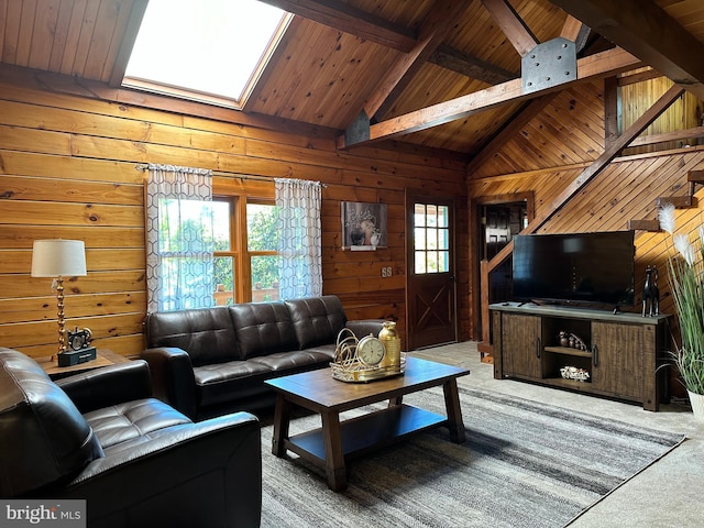 living room featuring carpet, wood walls, a skylight, beamed ceiling, and wood ceiling