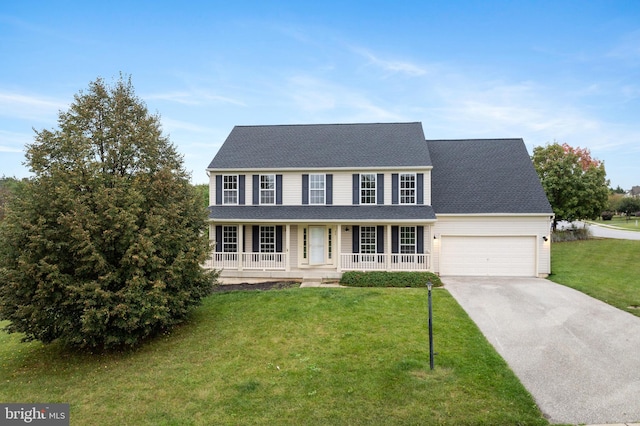 colonial-style house with a front yard, a porch, and a garage