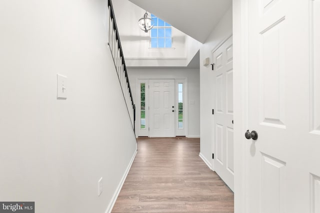 interior space featuring hardwood / wood-style floors and a notable chandelier