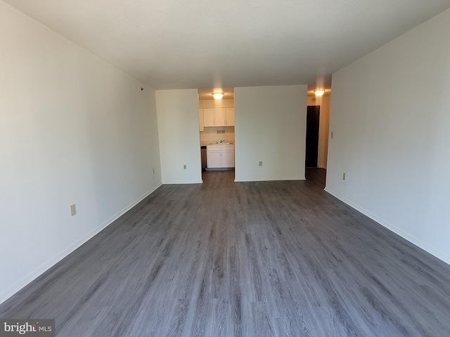 unfurnished living room featuring dark wood-type flooring