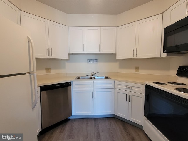 kitchen with white cabinets, white appliances, dark hardwood / wood-style floors, and sink