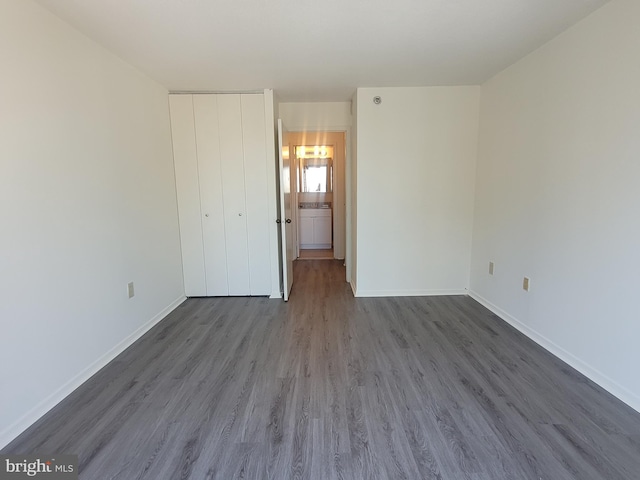 unfurnished bedroom with hardwood / wood-style flooring and ensuite bath