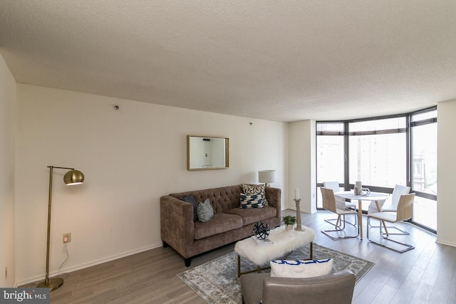 living room featuring a wall of windows, a textured ceiling, and hardwood / wood-style flooring