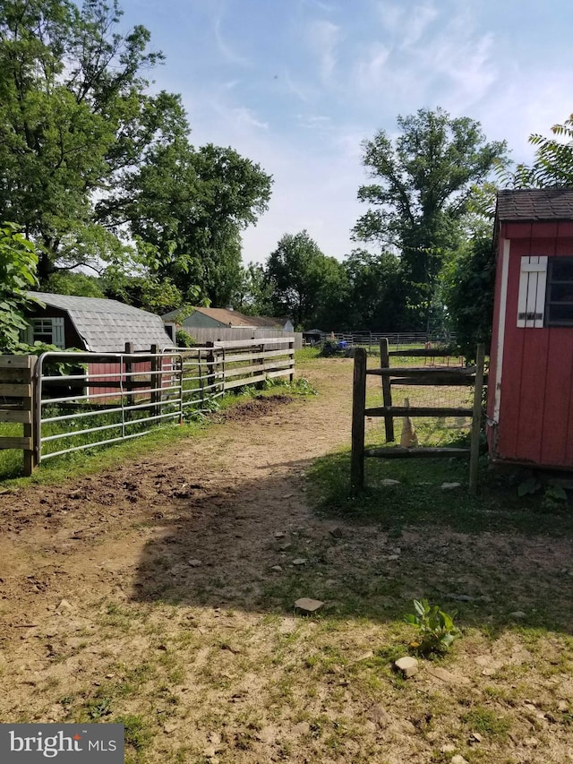 view of gate with a rural view