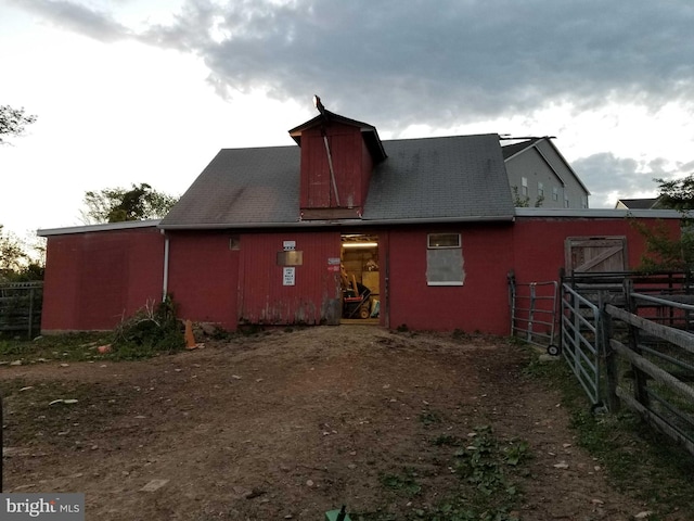 rear view of property with an outbuilding